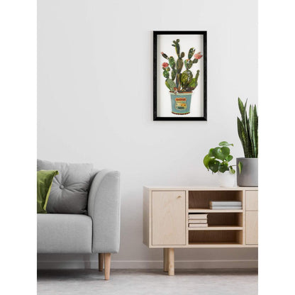 Die kreative 3D-Collage "Kaktus in der Vase" im modernen Wohnraum, angrenzend an ein Sofa und Pflanzen, die das Kunstwerk zur Geltung bringen.