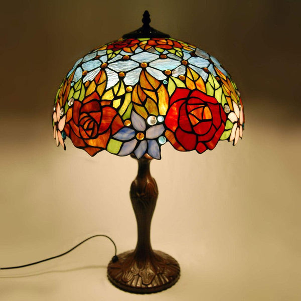 Florale Tischlampe. Tischlampe mit geschweißtem Glasschirm, Tiffany-Verarbeitung und Stütze aus bronziertem Metall - Designerobjekte.com