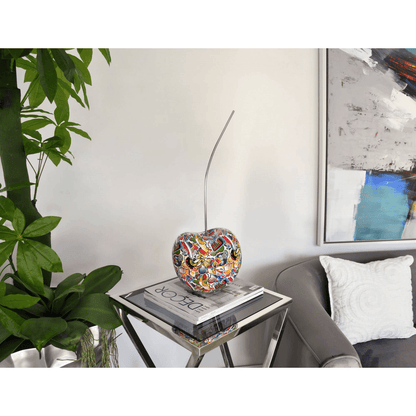 Designer Skulptur aus Kunstharz – Pop Art Meisterwerk in lebendigen Farben, präsentiert auf einem modernen Tisch im Wohnraum, umgeben von stilvollem Interieur.