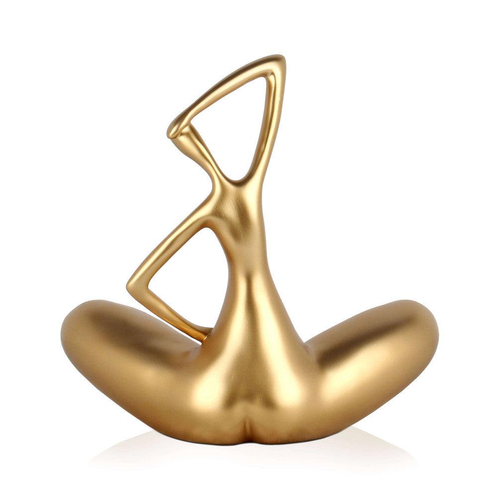 Kleine Evolution – Moderne Kunstharzskulptur mit Goldmetalleffekt, zeigt eine künstlerische Darstellung einer sitzenden Figur mit geschwungenen Formen.