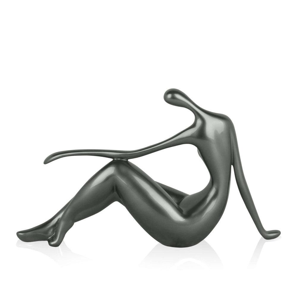 Kleine Ruhe: Elegante Skulptur in Anthrazit mit Metalleffekt, stilisierte Figur in entspannter Pose.