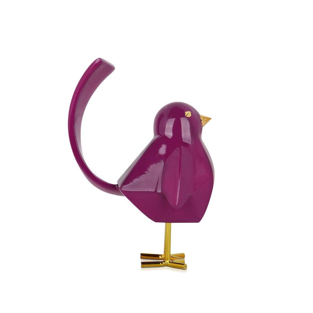 Moderne geometrische Vogel-Skulptur aus lilafarbenem Kunstharz mit goldenen Metalleinsätzen, seitliches Profil, perfekt für kreative Raumgestaltung