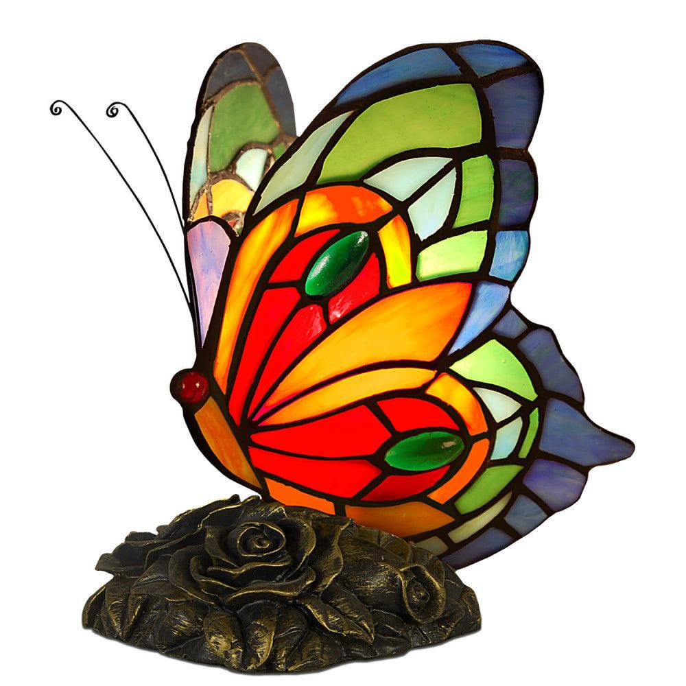 Tiffany Nachttischlampe im Schmetterlingsdesign in lebhaften Farben, gesehen von der Vorderseite, die bunten Glasdetails und der bronzierte Sockel sind deutlich sichtbar.