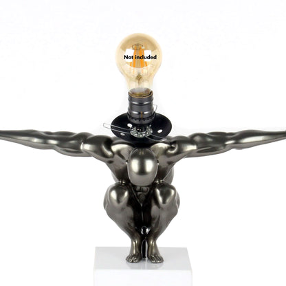 Moderne Tischlampe Equilibrio Anthrazit - Kunstharz mit Metalloptik und Marmorsockel, bietet stilvolle Beleuchtung und skulpturale Ästhetik im Wohnzimmer.